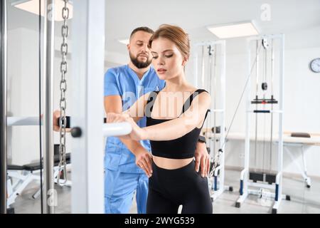Female patient is engaged in a kinesiology clinic Stock Photo