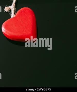 Two red heart wood chains on a black background Stock Photo
