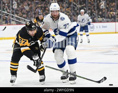 Pittsburgh, United States. 06th Apr, 2024. Pittsburgh Penguins center Sidney Crosby (87) clears to the puck away from Tampa Bay Lightning defenseman Victor Hedman (77) during the first period at PPG Paints Arena in Pittsburgh on Saturday, April 6, 2024. Photo by Archie Carpenter/UPI. Credit: UPI/Alamy Live News Stock Photo