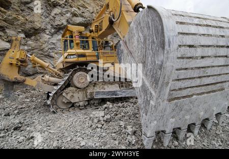 Extracting raw material from quarry for cement manufacturing. Stock Photo