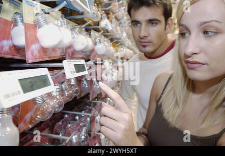 Couple looking at electronic price displays at Eroski shopping center. These displays are updated by remote control. Urbil. Usurbil. Guipuzcoa. Basque Country. Spain. Stock Photo