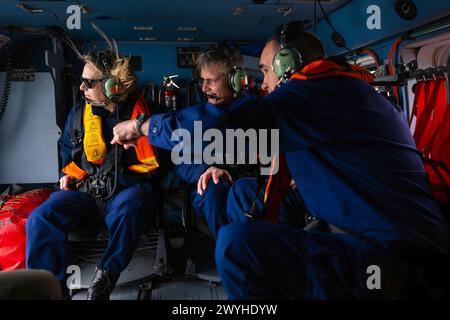 Adm. Linda L. Fagan, commandant of the Coast Guard, Vice Adm. Peter W. Gautier, deputy commandant for operations, and Rear Adm. Shannon N. Gilreath, fifth district commander, take an overflight assessment of the Francis Scott Key Bridge collapse in Baltimore, Maryland, March 29, 2024. The Key Bridge was struck by the Singapore-flagged cargo ship Dali early morning on March 26, 2024. (U. S. Coast Guard photo by Petty Officer 1st Class Brandon Giles) Stock Photo