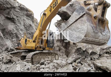 Extracting raw material from quarry for cement manufacturing. Stock Photo