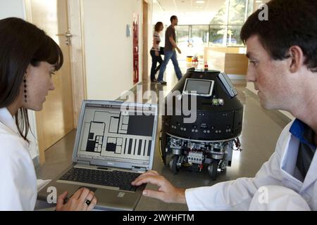 Researchers demonstrating a robot autonomous navigation capability using environment representation, Fatronik-Tecnalia, Research and Technology Center, Donostia, Basque Country, Spain. Stock Photo