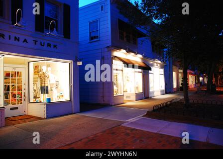 The windows of the luxury and high end stores are illuminated on the main street in East Hampton, one of the wealthy towns of the Hamptons Long Island Stock Photo