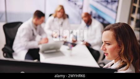 Discussing Health Diagnosis And X-ray. Professional Medical Group Stock Photo