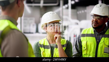 Factory Engineer Team Talking At Industrial Manufacturing Plant Stock Photo