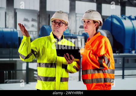 Electricity Plant Operators In Hardhats. AI Heating System Stock Photo