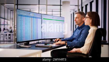 Analyst Employee Working On Spreadsheet Using Desktop Computer Stock Photo