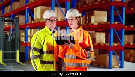 Osha Inspection Using Tablet. Inspecting Warehouse Inventory Stock Photo