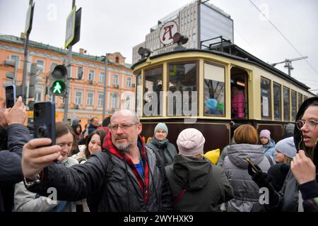 Beijing, Russia. 6th Apr, 2024. A man takes a selfie in front of a tram after a parade of retro tramways in Moscow, Russia, on April 6, 2024. The parade of retro tramways was held on Saturday to mark the 125th anniversary of the opening of the first tram line in Moscow. Credit: Alexander Zemlianichenko Jr/Xinhua/Alamy Live News Stock Photo