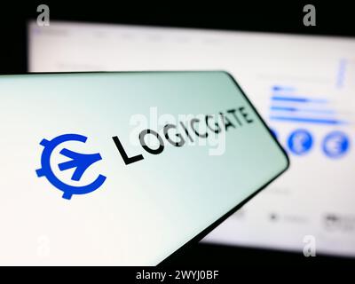 Mobile phone with logo of American risk management technology compnay LogicGate Inc. in front of website. Focus on left of phone display. Stock Photo