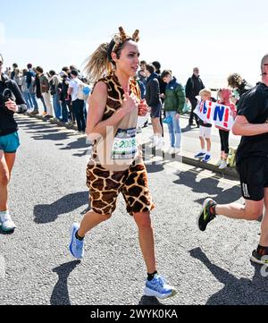 Brighton UK 7th April 2024 - Thousands of runners, some in fancy dress take part in the Brighton Marathon on a bright sunny but windy day  : Credit Simon Dack / Alamy Live News Stock Photo