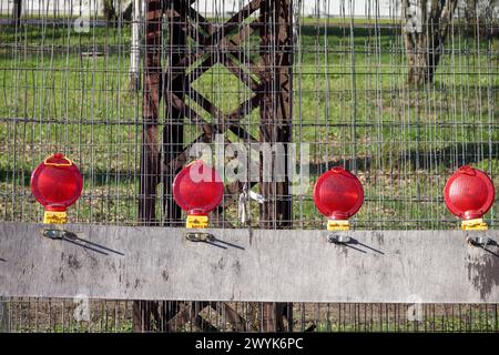 red and yellow lanterns on the street during repair work Stock Photo