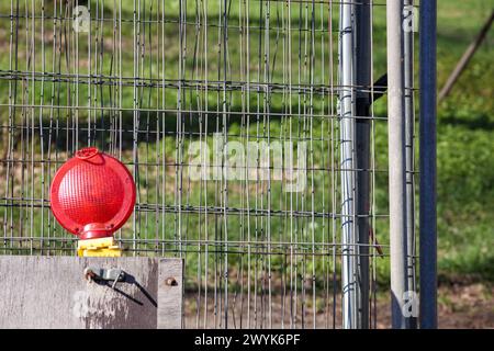 red and yellow lanterns on the street during repair work Stock Photo