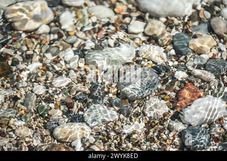 Top view of the stones in the water at the seaside and the sparkles of the water Stock Photo