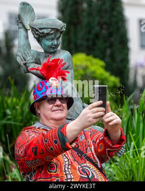 London, UK.  7 April 2024.  A hat wearing enthusiast takes part in London Hat Walk from Piccadilly to The Mall and then to the Queen Victoria Memorial, on the 10th anniversary of the very first London Hat Week.  The event is also part of the World Hat Walk, with similar hat walks taking place internationally.  Credit: Stephen Chung / Alamy Live News Stock Photo