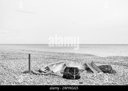 Boat and lobster pots abandoned on the beach Stock Photo