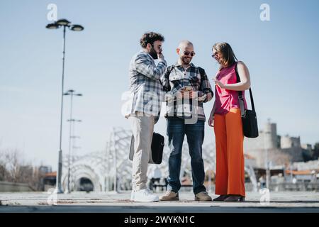 Young business people collaborating in an urban city area discussing strategy and marketing Stock Photo