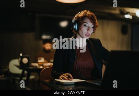 Confident businesswoman working alone, analyzing market data, discussing new project, strategizing for business expansion. Stock Photo