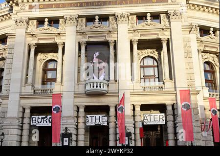 Vienna, Austria. 06th Apr, 2024. The Vorarlberg artist and musician Wolfgang Flatz adapted Hitler's Pearl Speech from 1938 for an action in and in front of the Burgtheater in Vienna. Instead of the swastika, there is a dog's head in the middle of the red flags Stock Photo