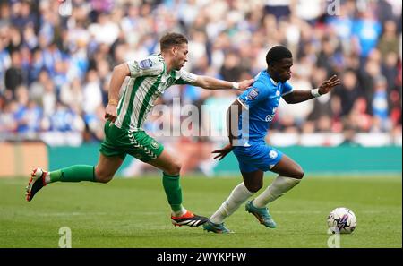 Peterborough United's Kwame Poku in action against Wycombe Wanderers's Luke Leahy during the Bristol Street Motors Trophy final at Wembley Stadium, London. Picture date: Sunday April 7, 2024. Stock Photo