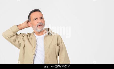 Puzzled senior scratching head in confusion, copy space Stock Photo