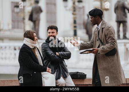 A diverse group of young business coworkers engaging in a collaborative discussion outdoors, showcasing teamwork and flexibility in an urban setting. Stock Photo