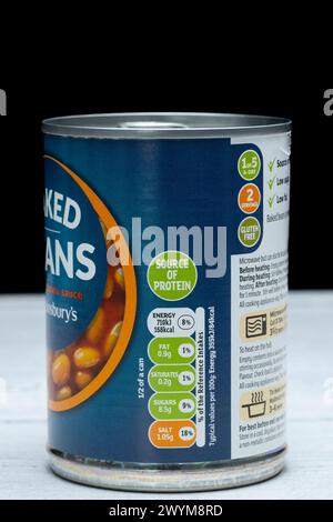 Irvine, Scotland, UK - March 26, 2024: Sainsbury’s baked beans in a tin can displaying graphics Kcal icons and general information relevant to the ima Stock Photo
