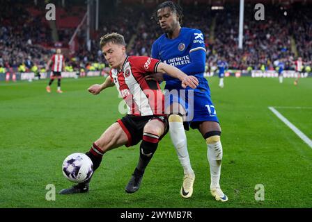 Sheffield United's Ben Osborn (left) and Chelsea's Carney Chukwuemeka battle for the ball during the Premier League match at Bramall Lane, Sheffield. Picture date: Sunday April 7, 2024. Stock Photo