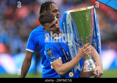 London, UK. 07th Apr, 2024. Harrison Burrows of Peterborough United with the trophy during the EFL Trophy Final between Peterborough United and Wycombe Wanderers at Wembley Stadium, London, England on 7 April 2024. Photo by Carlton Myrie. Editorial use only, license required for commercial use. No use in betting, games or a single club/league/player publications. Credit: UK Sports Pics Ltd/Alamy Live News Stock Photo
