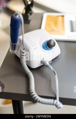 Electric manicure machine on table. Drill for manicure Stock Photo