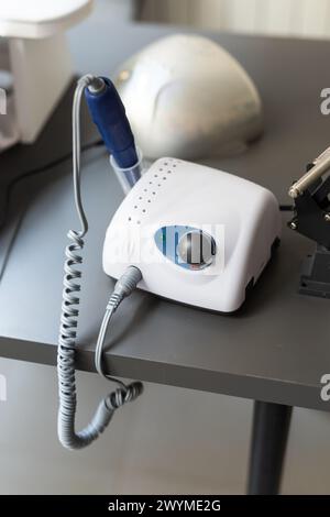 Electric manicure machine on table. Drill for manicure Stock Photo
