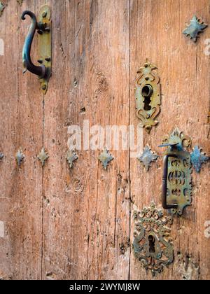 Locks and knockers on an old wooden door Stock Photo