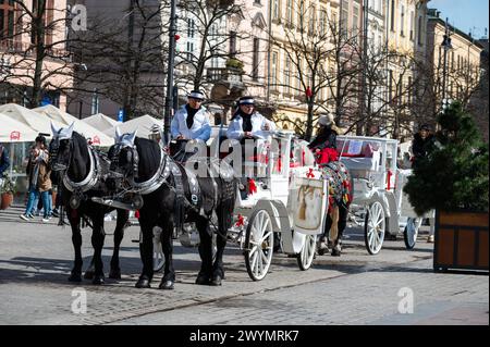 Krakow, Lesser Poland, March 19, 2024 - Horse and carriage at the old market square Stock Photo