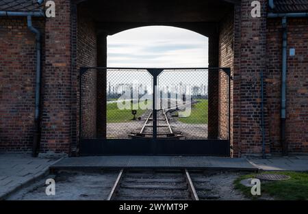 Auschwitz, Poland, March 21, 2024 - Railway track and gate of the extermination camp Stock Photo