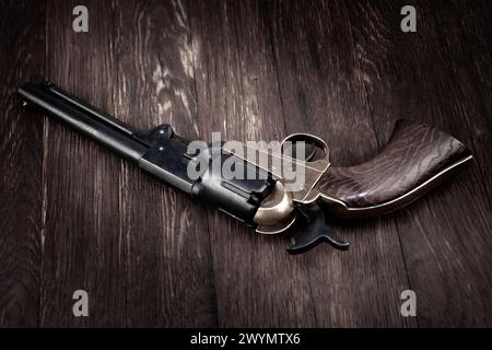 Old West gun. Percussion Army Revolver on wooden table Stock Photo