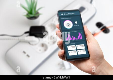 Man using the smart power strip. Electrical plug in outlet socket at home. Stock Photo