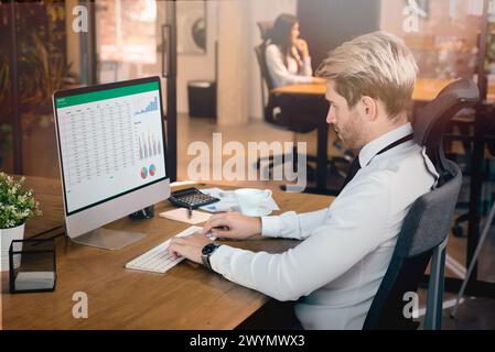 Analyst working on a spreadsheet. Report on screen Stock Photo