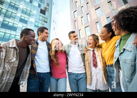 Happy group of young European student friends having fun together and hugging outdoors Stock Photo