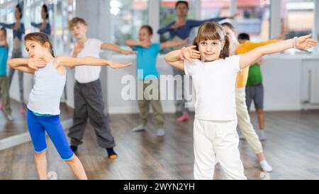 Dance class for kids, girls and boys training in dance studio Stock Photo