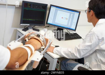 Researcher placing a patient clinical training device of the limb has multiple modes of training wrist and arm This is a quantitative and repetitive haptic training Rehabilitation hospitals, Unit of Health Technology, Tecnalia Research & Innovation, Miramon Technology Park, San Sebastian, Donostia, Gipuzkoa, Basque Country, Spain. Stock Photo