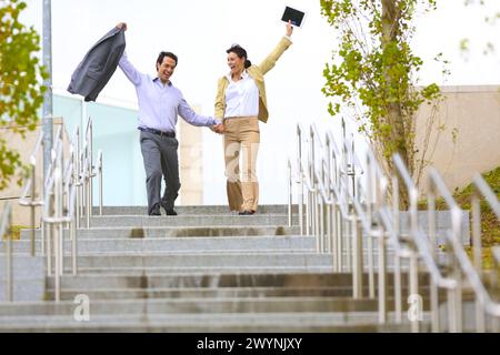 Business couple jumping stairs. San Sebastian Technology Park. Donostia. Gipuzkoa. Basque Country. Spain. Stock Photo