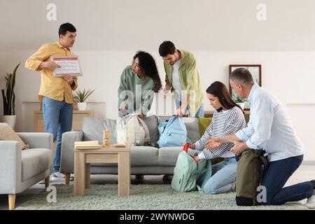 People with evacuation plan packing things indoors Stock Photo