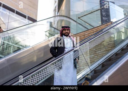 arabic man on escalator Stock Photo