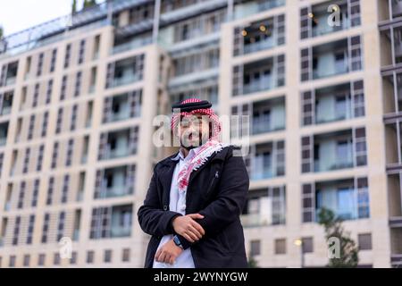 portrait for arabic young male wearing traditional clothes with modern background and blurred lights Stock Photo