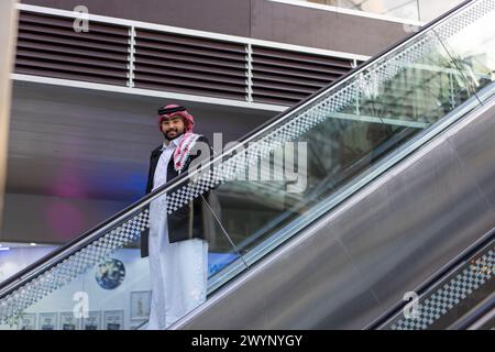 arabic man on escalator Stock Photo