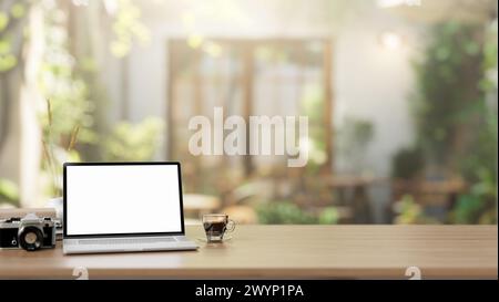 A white-screen laptop computer mockup is placed on a wooden table in a green comfortable cafe on a sunny day. close-up workspace concept. 3d render, 3 Stock Photo