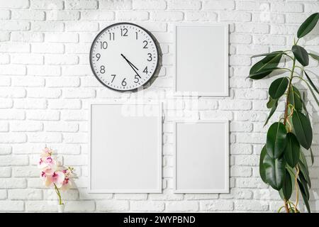 Minimalist White Wall Display With Clock and Empty Frames in a Modern ...