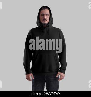 Mockup of a black oversized hoodie on a brutal man in a hood, wide clothing with a pocket, laces, cuff, front. Apparel template for design, branding, Stock Photo